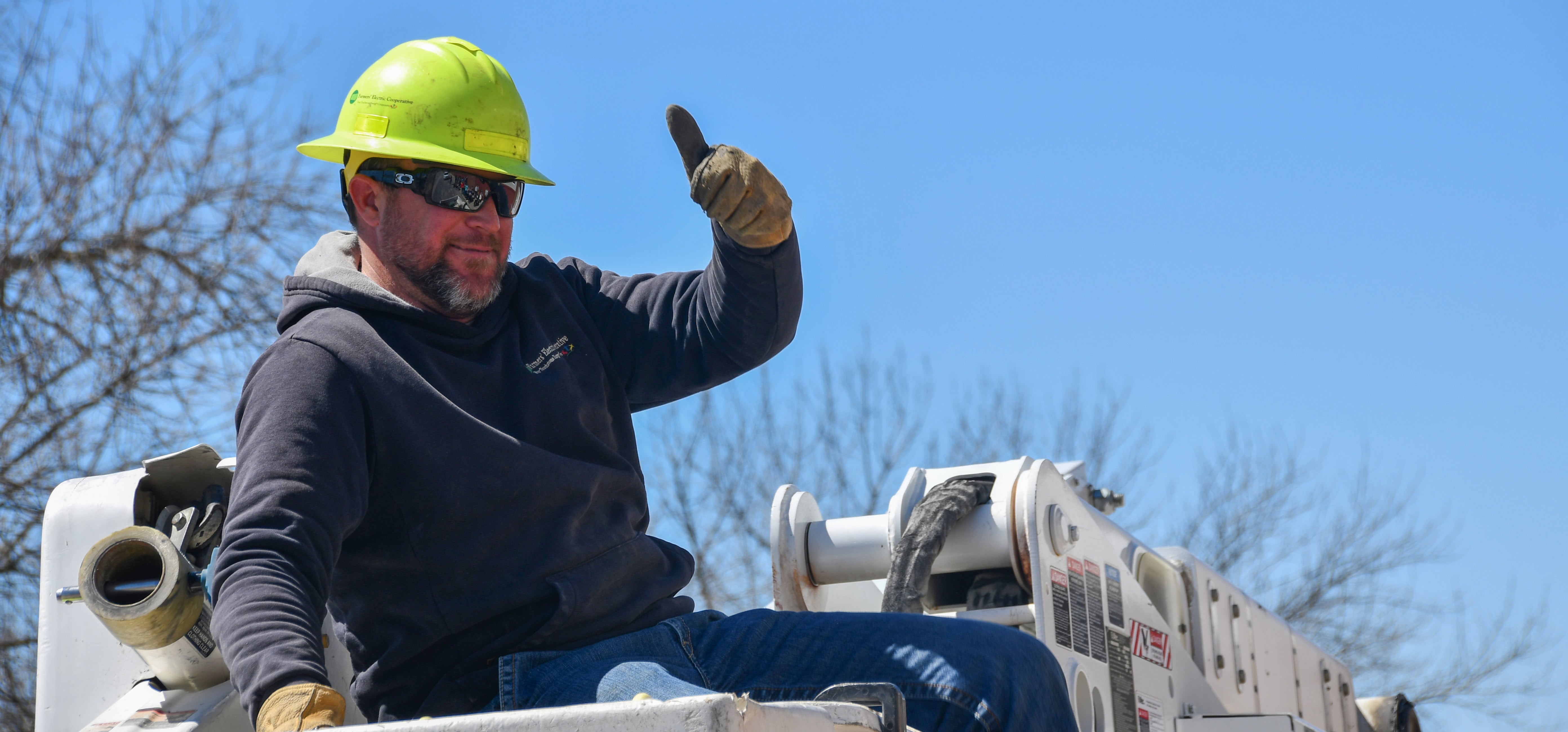Lineman gives thumbs up from the bucket truck