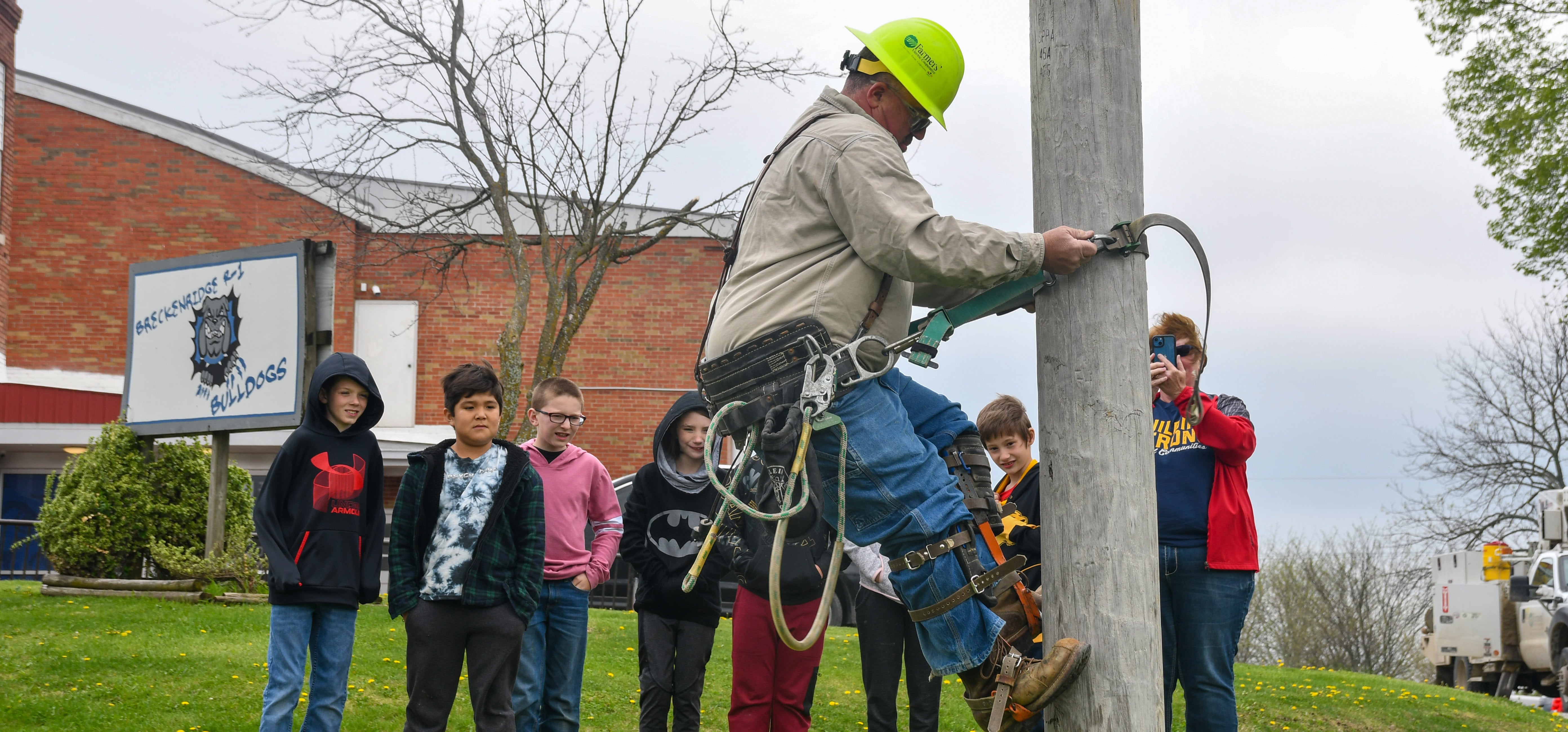 Lineman climbing a pole in Breckenridge