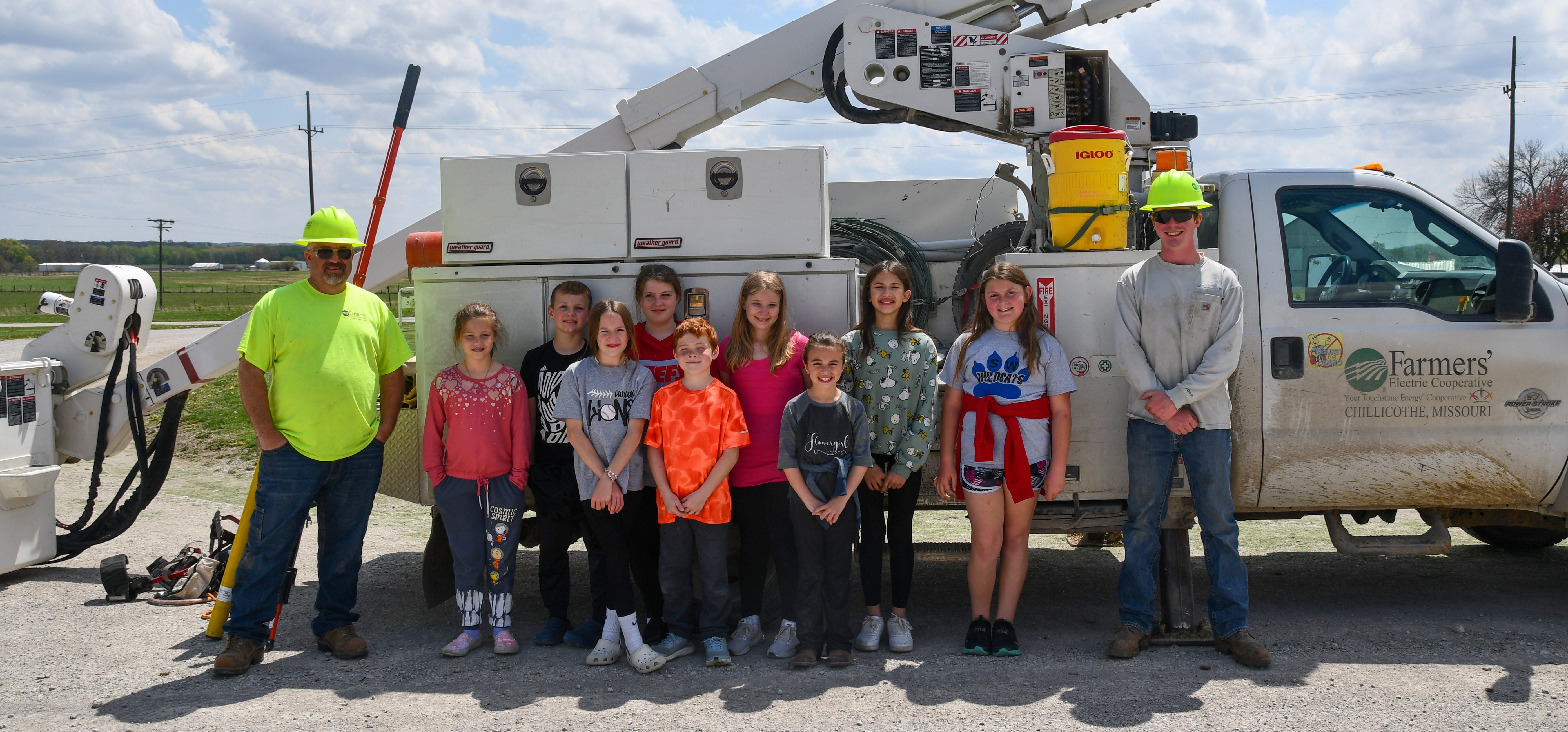 Southwest school class with linemen and bucket truck